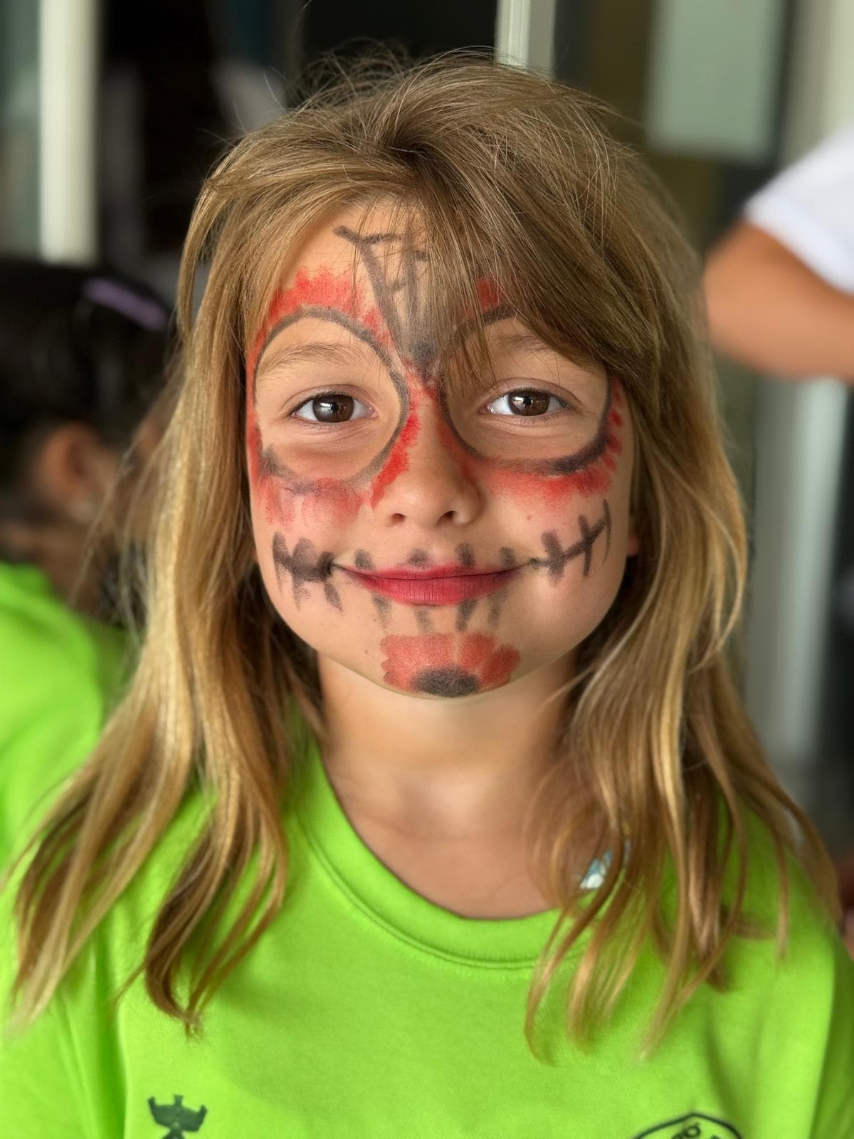 Nena amb pintacares de Halloween somrient